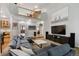 Open-concept living room with soaring ceilings, large windows, and comfortable sectional sofa at 16326 E Dorado Ave, Centennial, CO 80015