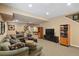 Finished basement offering a large sectional sofa, TV area, and game room at 16326 E Dorado Ave, Centennial, CO 80015