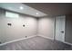 Cozy finished basement space with neutral carpet, paint, window, and laundry hookups, offering comfort and functionality at 4854 S Parfet St, Littleton, CO 80127