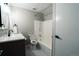 Bathroom featuring a shower-tub combination and a modern vanity with sleek fixtures at 4854 S Parfet St, Littleton, CO 80127