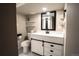 Updated bathroom features modern vanity with white countertop, black fixtures, and stylish sliding barn door accents at 4854 S Parfet St, Littleton, CO 80127