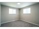 Cozy bedroom with plush gray carpeting and natural light streaming through the windows at 4854 S Parfet St, Littleton, CO 80127