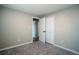 Comfortable bedroom featuring neutral walls, carpet flooring, and a closet with ample storage space at 4854 S Parfet St, Littleton, CO 80127