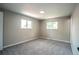Inviting bedroom with neutral paint, plush carpeting, and plenty of natural light from two windows at 4854 S Parfet St, Littleton, CO 80127
