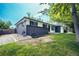 Charming home boasts a beautifully landscaped yard and a striking dark brick exterior, exuding curb appeal at 4854 S Parfet St, Littleton, CO 80127