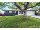 Charming home exterior featuring a well-manicured lawn and a large shade tree in the front yard at 4854 S Parfet St, Littleton, CO 80127