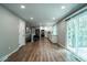 Open-concept kitchen and dining area featuring stainless steel appliances and a sliding glass door to the patio at 4854 S Parfet St, Littleton, CO 80127