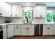 Bright, updated kitchen featuring white cabinets, modern appliances, and a stylish backsplash at 4854 S Parfet St, Littleton, CO 80127