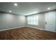 Bright living room featuring wood floors, neutral paint, and a window with blinds, creating a cozy atmosphere at 4854 S Parfet St, Littleton, CO 80127
