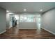 Bright, open living space with wood floors and a view into the modern, updated kitchen at 4854 S Parfet St, Littleton, CO 80127