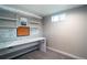 Bright office space features a large desk with shelving, window and neutral colored walls at 4854 S Parfet St, Littleton, CO 80127