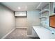 Carpeted office space with a large desk, floating shelves, and storage cabinets at 4854 S Parfet St, Littleton, CO 80127