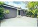 Back patio with sliding glass door access to the home and manicured landscaping at 4854 S Parfet St, Littleton, CO 80127