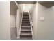 Carpeted staircase with white handrail leading to the upper level of the home at 4854 S Parfet St, Littleton, CO 80127