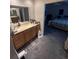 Bathroom with double sinks and vanity that leads into the carpeted bedroom at 14131 E Baltic Pl, Aurora, CO 80014