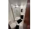 Bathroom featuring a tile shower with glass door and a sleek dark vanity at 14131 E Baltic Pl, Aurora, CO 80014