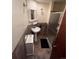 Bathroom featuring a pedestal sink, tiled walls, and a compact shower stall at 14131 E Baltic Pl, Aurora, CO 80014