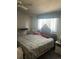 Bedroom featuring a window and striped bedding, lit by a ceiling fan for comfortable living at 14131 E Baltic Pl, Aurora, CO 80014
