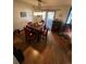 Cozy dining room with hardwood floors, a chandelier, and a sliding door that leads to the outdoor deck at 14131 E Baltic Pl, Aurora, CO 80014