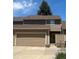 Charming townhome featuring a two-car garage and neutral-tone exterior for a welcoming curb appeal at 14131 E Baltic Pl, Aurora, CO 80014