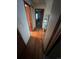 Hallway with wood floors and doors that open into different rooms of the home at 14131 E Baltic Pl, Aurora, CO 80014