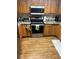 Well-appointed kitchen featuring stainless steel appliances, wood cabinets, and hardwood floors for a cozy feel at 14131 E Baltic Pl, Aurora, CO 80014