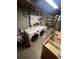Laundry area with modern washer and dryer units, storage shelves and utility sink at 14131 E Baltic Pl, Aurora, CO 80014