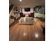 Living room with cozy seating and wood floors decorated with art and memorabilia at 14131 E Baltic Pl, Aurora, CO 80014