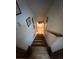 A view down a wooden staircase with white walls decorated with framed pictures at 14131 E Baltic Pl, Aurora, CO 80014