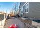 Gravel backyard featuring cornhole boards, string lights, and an exterior view of the house at 14232 Elm St, Thornton, CO 80602
