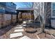 Landscaped backyard featuring a pergola, gravel, stepping stones, and planting beds at 14232 Elm St, Thornton, CO 80602