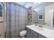 Well-lit bathroom featuring modern fixtures, framed art and a shower with stylish curtain at 14232 Elm St, Thornton, CO 80602