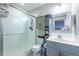 Modern bathroom with sleek vanity, mirrored cabinet, and a glass-enclosed shower with subway tile at 14232 Elm St, Thornton, CO 80602