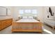 Bedroom featuring natural wood bed frame, neutral decor, and ample natural light at 14232 Elm St, Thornton, CO 80602