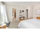 Bedroom featuring ensuite bathroom, walk-in closet, and natural light from glass door at 14232 Elm St, Thornton, CO 80602