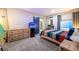 Comfortable bedroom featuring a barn door, an aquarium, a surfboard, and a large window at 14232 Elm St, Thornton, CO 80602