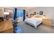 Bright bedroom with a white comforter, a desk, and a large window offering a view of Longs Peak at 14232 Elm St, Thornton, CO 80602