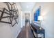 Elegant hallway with stylish decor, sleek hardwood floors, and a glimpse of the home's open layout at 14232 Elm St, Thornton, CO 80602