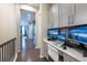 Upstairs landing converted to home office with built-in desk, monitors, and natural lighting at 14232 Elm St, Thornton, CO 80602