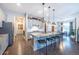 Open-concept kitchen featuring granite countertops, gray cabinetry, stainless appliances and pendant lighting over breakfast bar at 14232 Elm St, Thornton, CO 80602