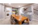 Spacious kitchen features grey tiling, stainless steel appliances, and a sizable island with a wooden table at 14232 Elm St, Thornton, CO 80602