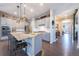 Stylish kitchen featuring a granite island with seating, stainless steel appliances, and sleek grey cabinetry at 14232 Elm St, Thornton, CO 80602