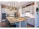 Stylish kitchen featuring stainless steel appliances, granite countertops, and a central island with pendant lighting at 14232 Elm St, Thornton, CO 80602