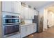 Modern kitchen with stainless steel appliances, gray cabinetry, and granite countertops at 14232 Elm St, Thornton, CO 80602