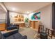 Comfortable living room with two dark blue couches, an artsy wall, decor, and neutral carpet at 14232 Elm St, Thornton, CO 80602