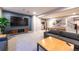 Basement living room with TV, blue wallpaper, a gray couch, and a view of the kitchen at 14232 Elm St, Thornton, CO 80602