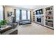 Bright living room features a fireplace, built-in shelving, gray sofa, and lots of natural light at 14232 Elm St, Thornton, CO 80602