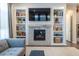 Cozy living room with a fireplace, built-in shelves, and stylish decor at 14232 Elm St, Thornton, CO 80602