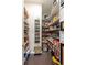 Well-stocked walk-in pantry with ample shelving for storage at 14232 Elm St, Thornton, CO 80602