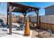 Inviting backyard with custom pergola, gravel, and landscaping, perfect for outdoor living at 14232 Elm St, Thornton, CO 80602